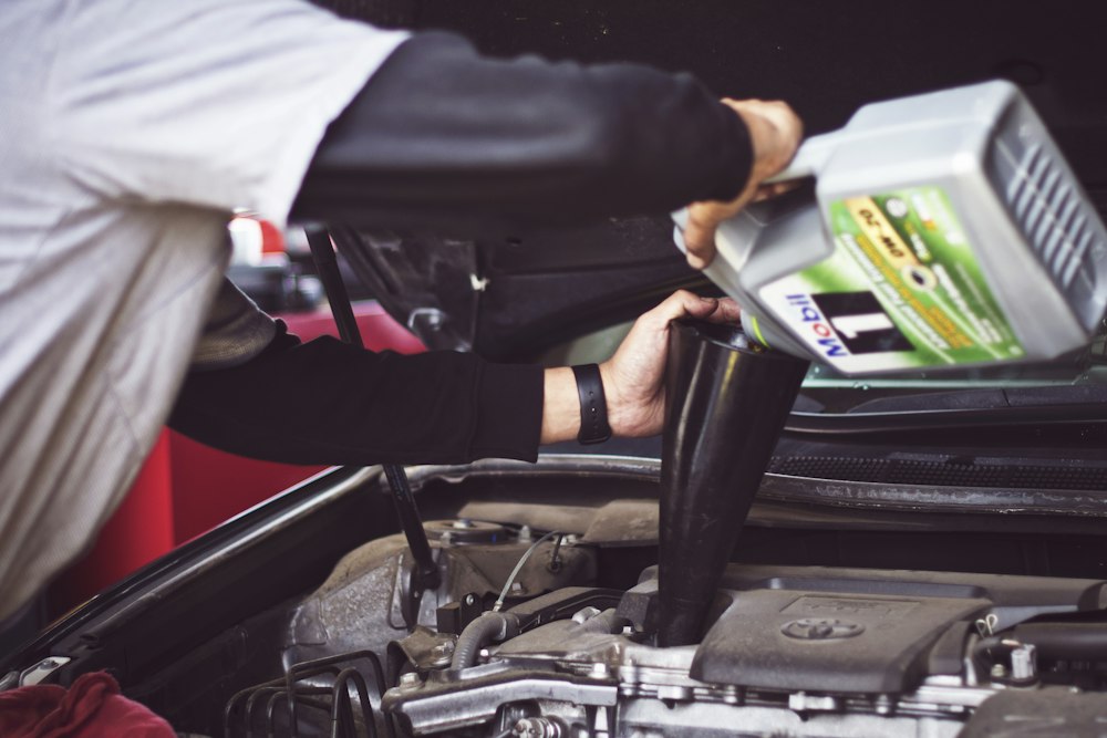 Technicians inspecting a vehicle engine